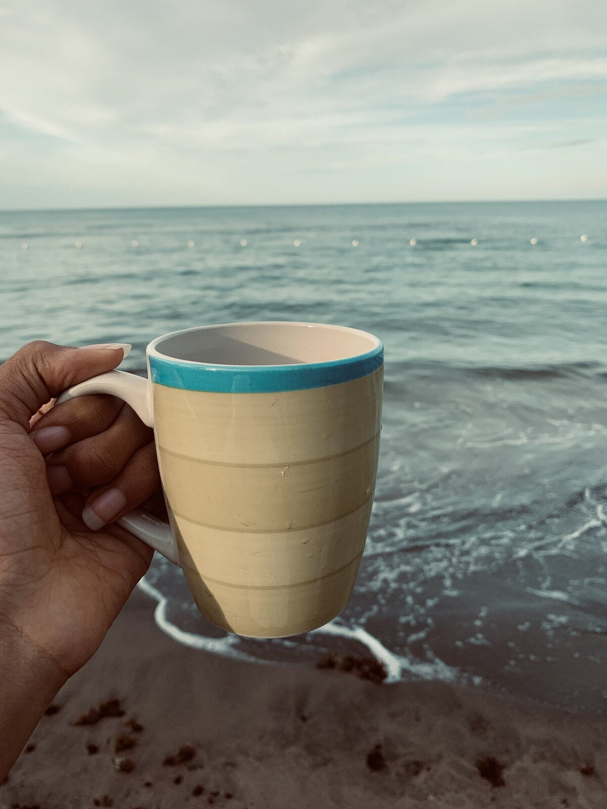 Sara's morning cup of Blue Mountain coffee on a Jamaican beach