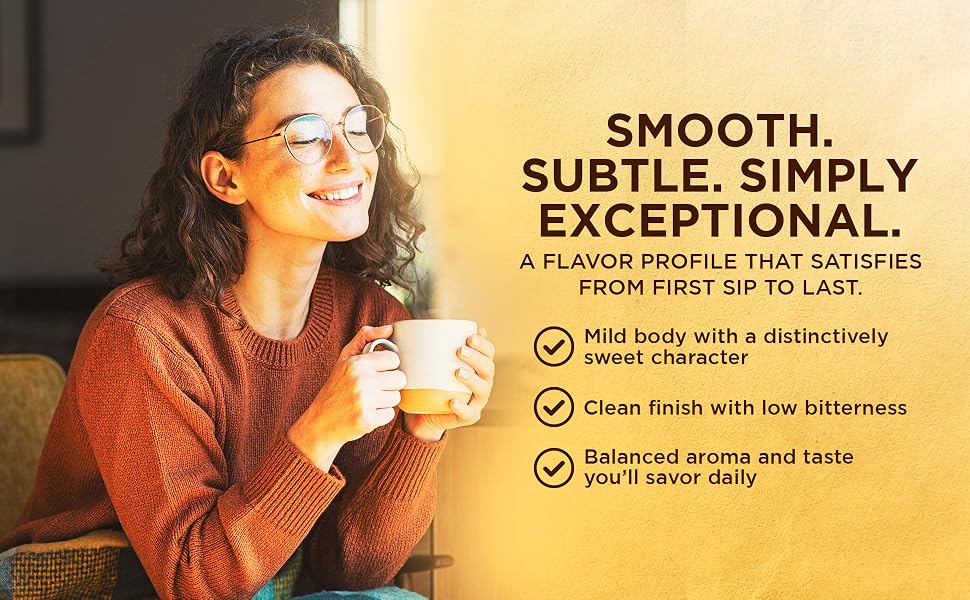 Woman smiling over a cup of coffee: smooth, subtle, clean finish with low bitterness